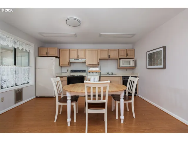 a view of kitchen with cabinets table and chairs