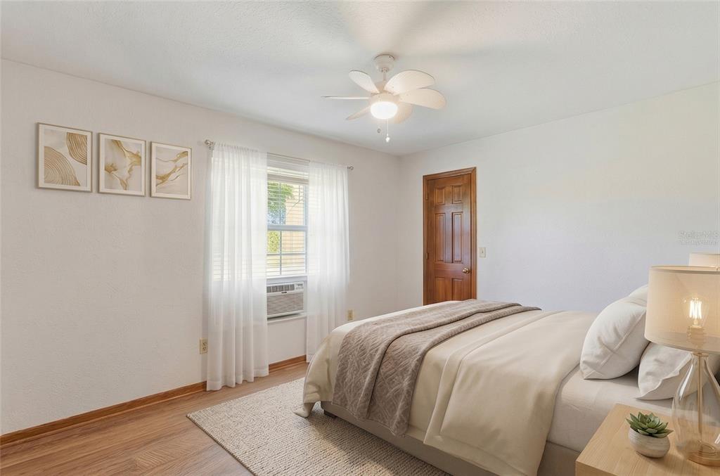 215 Santa Rosa Drive Winter Haven, FL 33884 - Photo 13 of 29 a bedroom with a bed and a chandelier