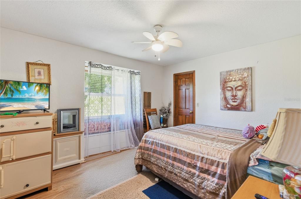215 Santa Rosa Drive Winter Haven, FL 33884 - Photo 14 of 29 a bedroom with a bed and a chandelier