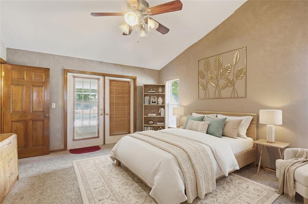 215 Santa Rosa Drive Winter Haven, FL 33884 - Photo 19 of 29 a bedroom with a large bed and a chandelier