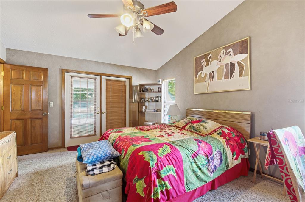 215 Santa Rosa Drive Winter Haven, FL 33884 - Photo 20 of 29 a bedroom with a bed and a chandelier