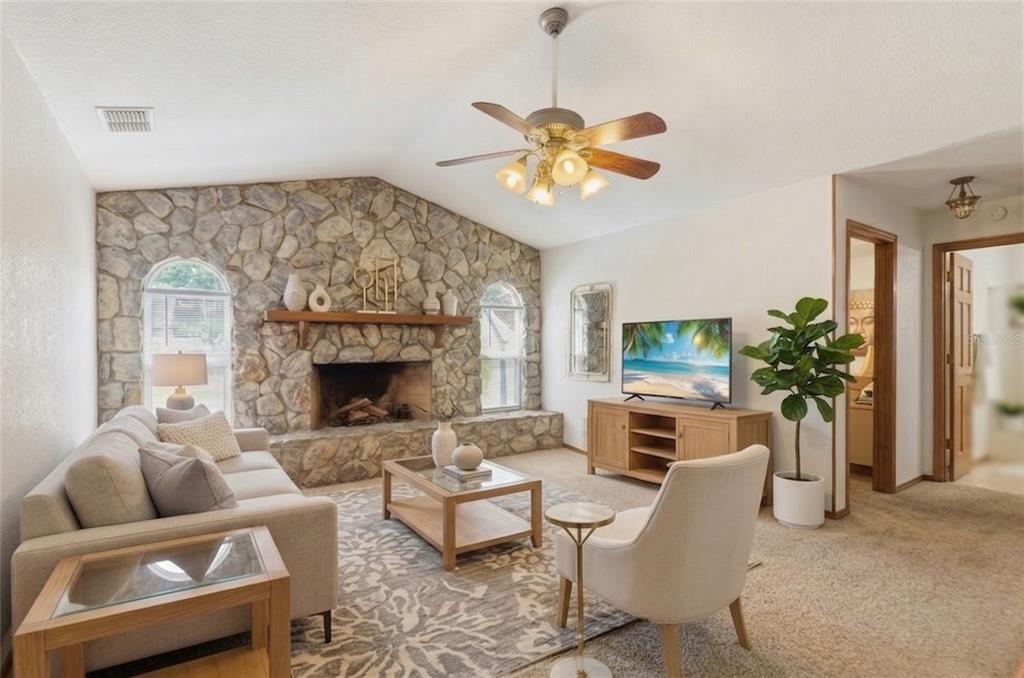 215 Santa Rosa Drive Winter Haven, FL 33884 - Photo 2 of 29 a living room with furniture a fireplace and a flat screen tv