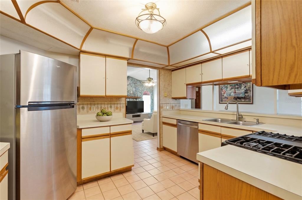 215 Santa Rosa Drive Winter Haven, FL 33884 - Photo 4 of 29 a kitchen with stainless steel appliances granite countertop a sink stove and refrigerator