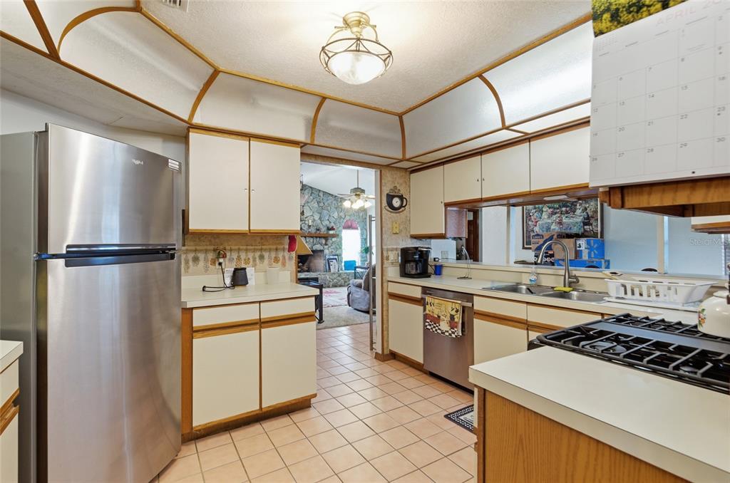 215 Santa Rosa Drive Winter Haven, FL 33884 - Photo 5 of 29 a kitchen with stainless steel appliances granite countertop a stove a refrigerator and a sink