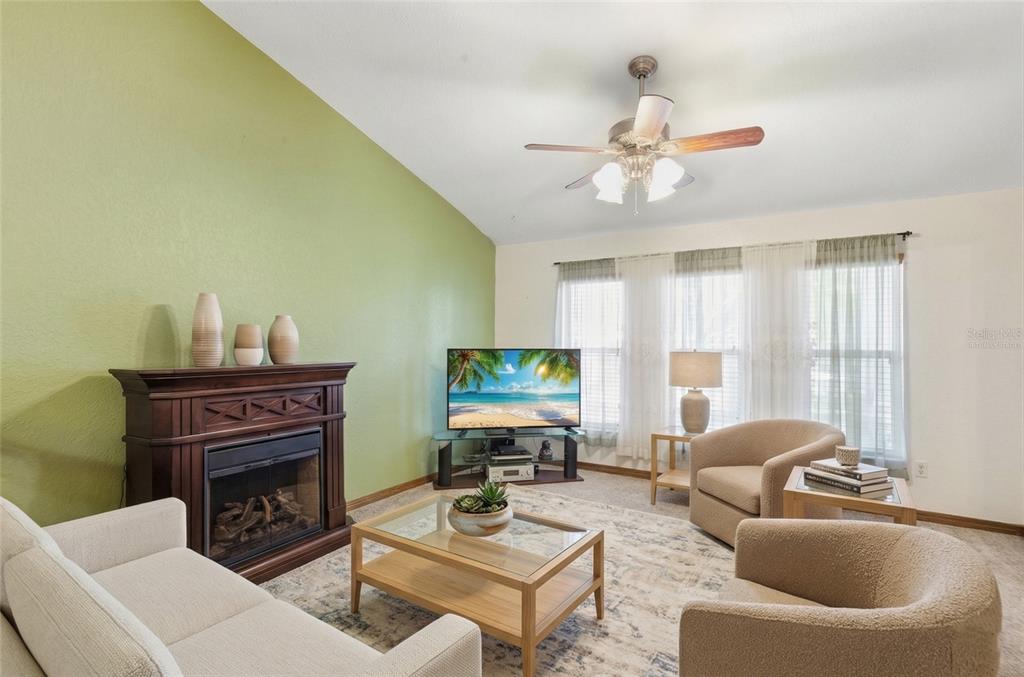 215 Santa Rosa Drive Winter Haven, FL 33884 - Photo 9 of 29 a living room with furniture a fireplace and a flat screen tv