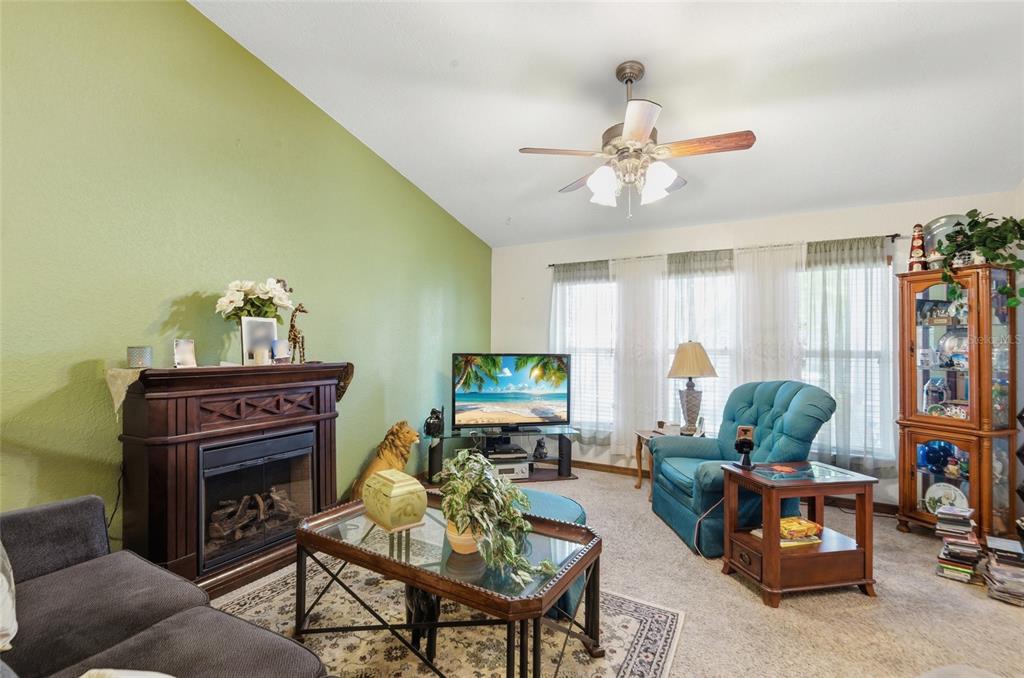 215 Santa Rosa Drive Winter Haven, FL 33884 - Photo 10 of 29 a living room with furniture a window and a chandelier