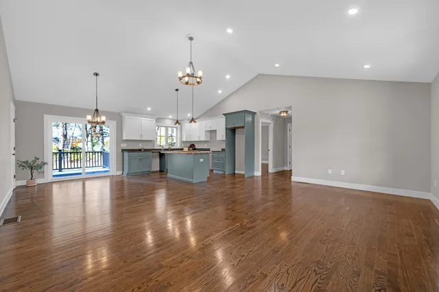 a large kitchen with stainless steel appliances granite countertop a stove and a refrigerator