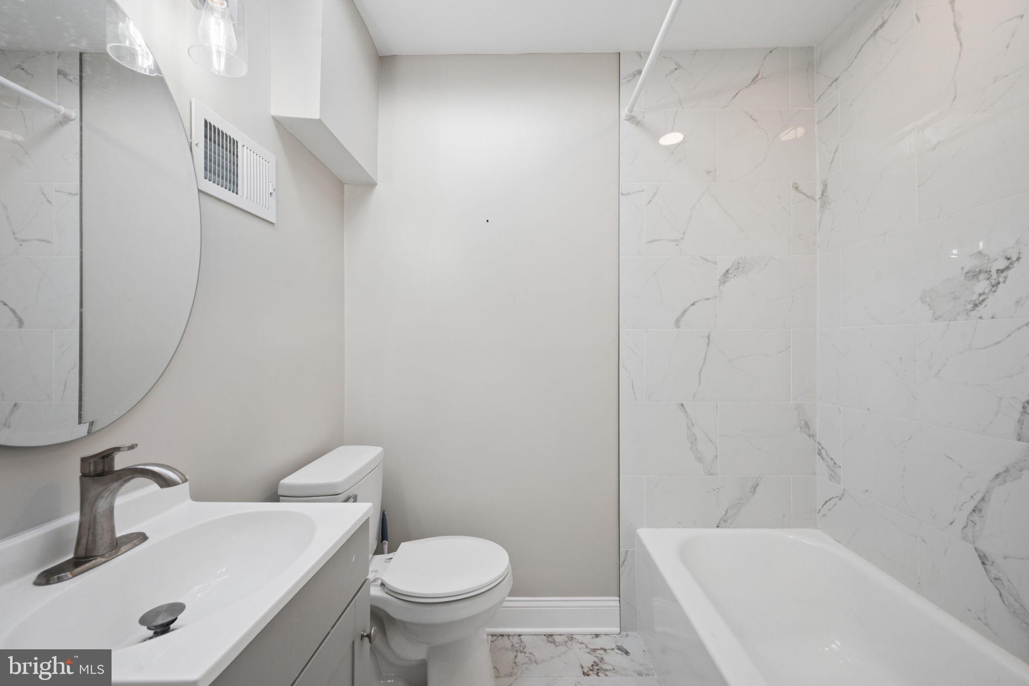 3548 Benzinger Road Baltimore, MD 21229 - Photo 18 of 40 a bathroom with a sink toilet and shower