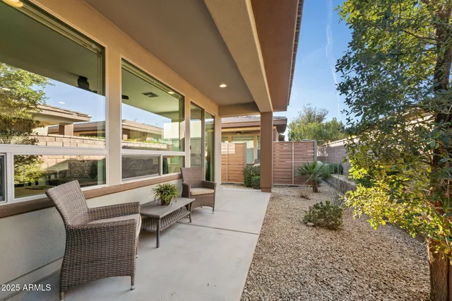 a building outdoor space with patio furniture and potted plants