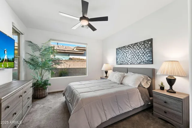 a bedroom with a large bed and a window