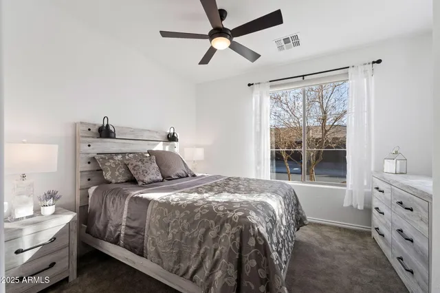 a bedroom with a bed and a window