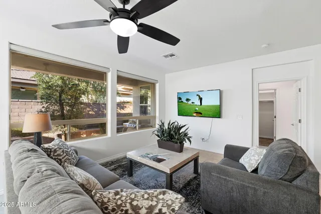 a living room with furniture and a large window