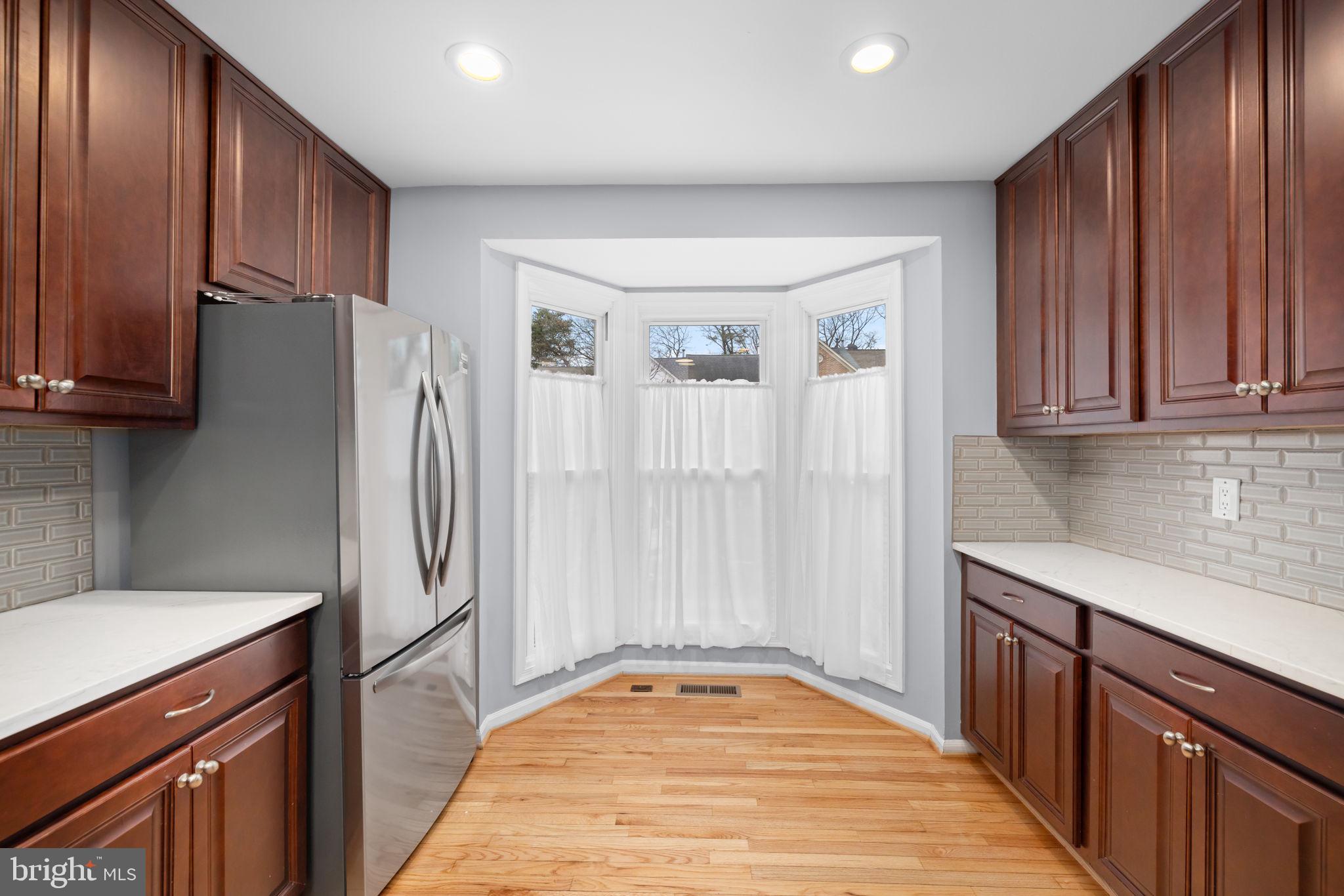 43861 Laburnum Square Ashburn, VA 20147 - Photo 13 of 46 a kitchen with stainless steel appliances granite countertop a refrigerator and a sink