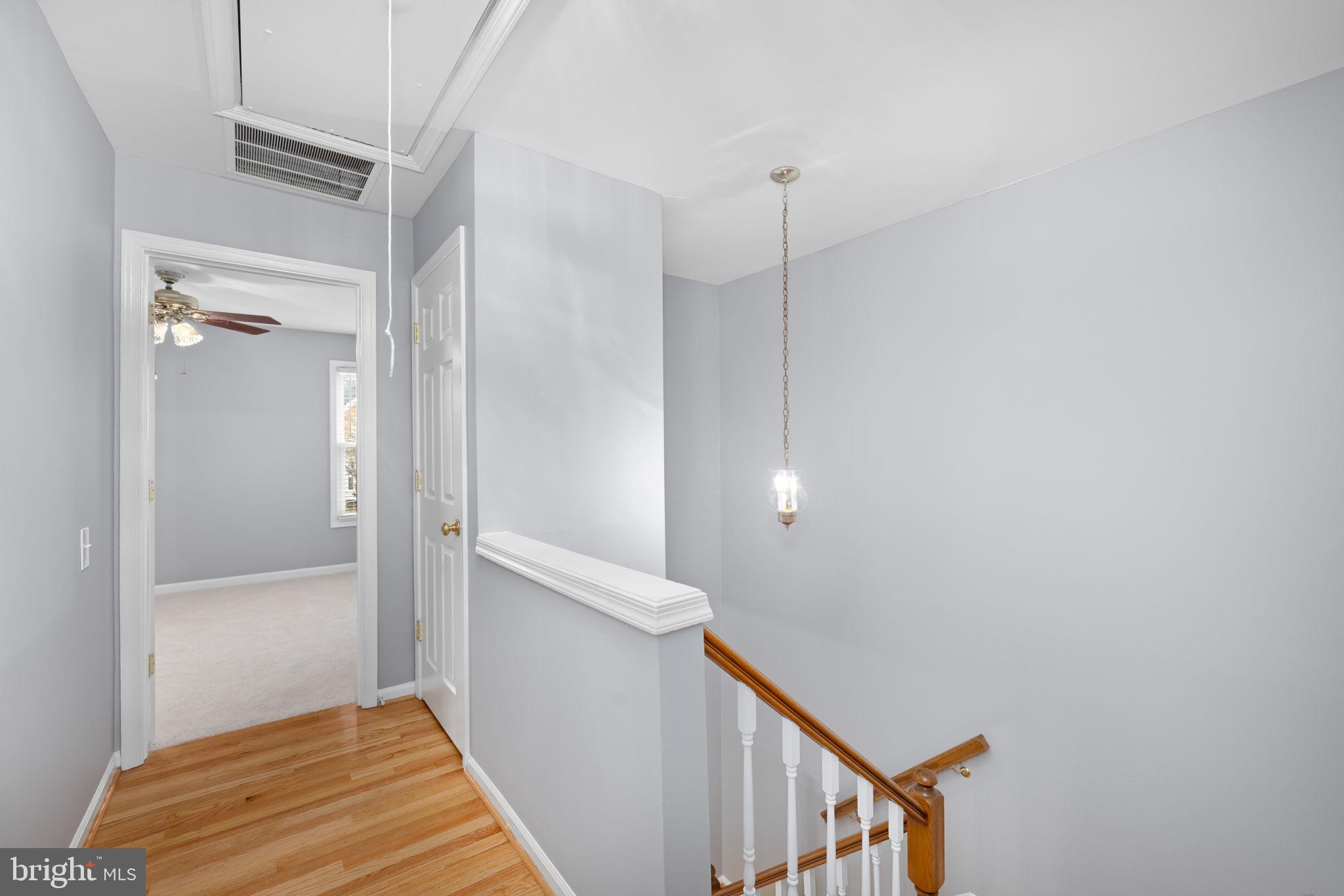 43861 Laburnum Square Ashburn, VA 20147 - Photo 30 of 46 a view of a hallway with stairs and a wooden floor