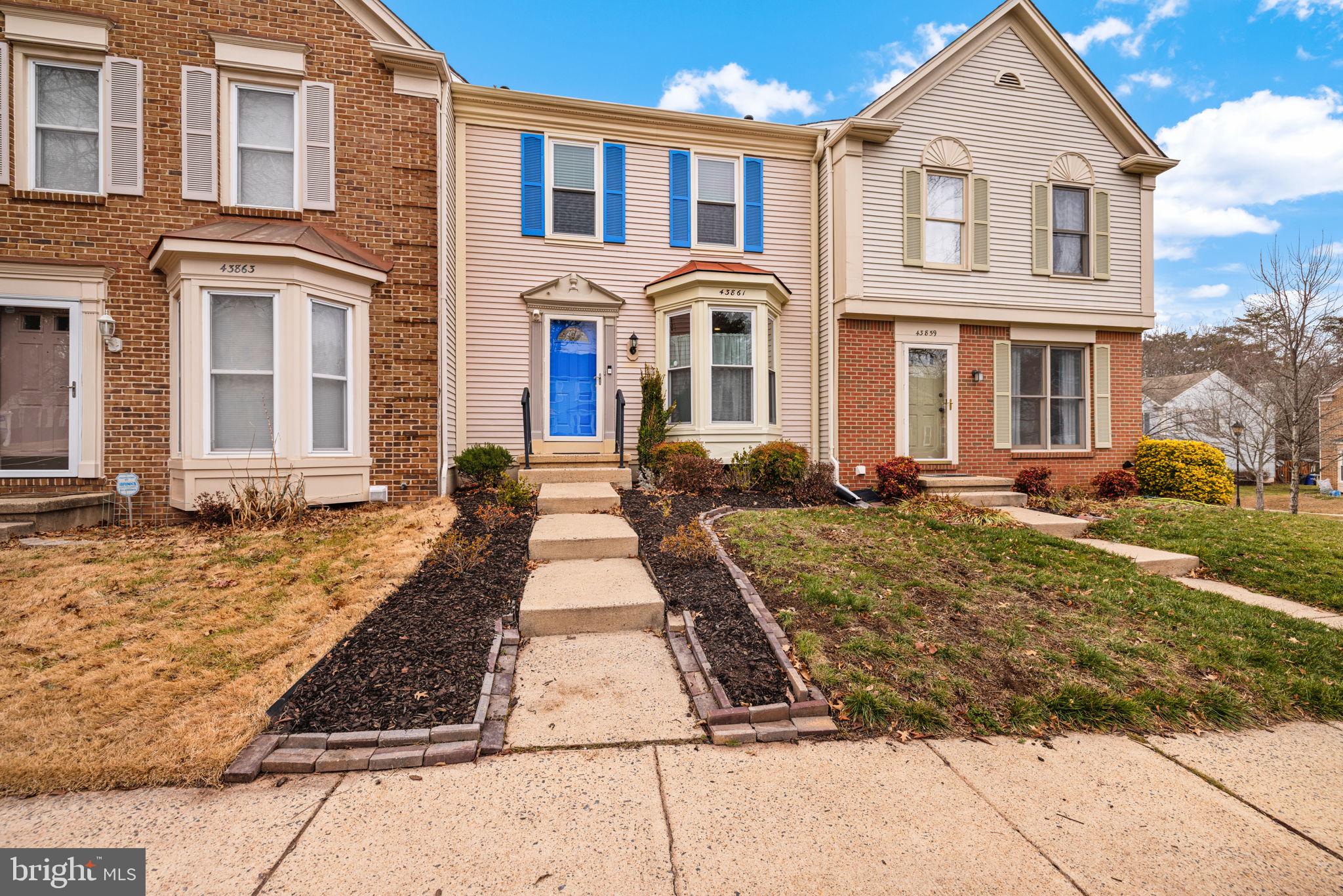 43861 Laburnum Square Ashburn, VA 20147 - Photo 3 of 46 a front view of a house with large windows