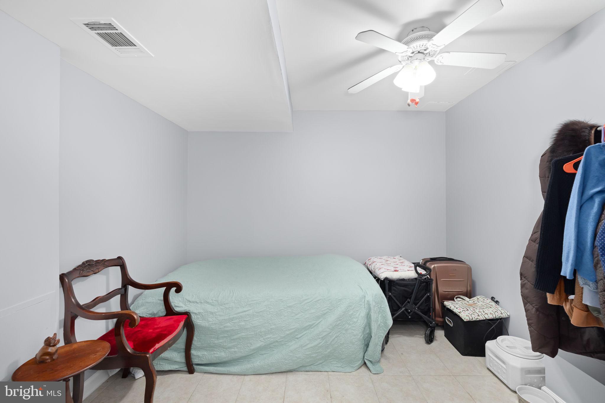 43861 Laburnum Square Ashburn, VA 20147 - Photo 34 of 46 a bedroom with a bed and a chandelier