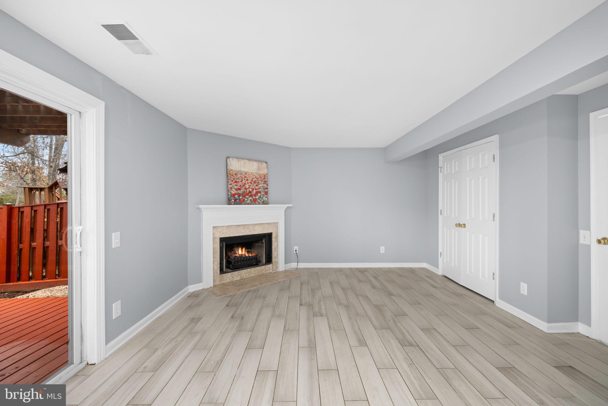 43861 Laburnum Square Ashburn, VA 20147 - Photo 37 of 46 a view of empty room with wooden floor and fireplace