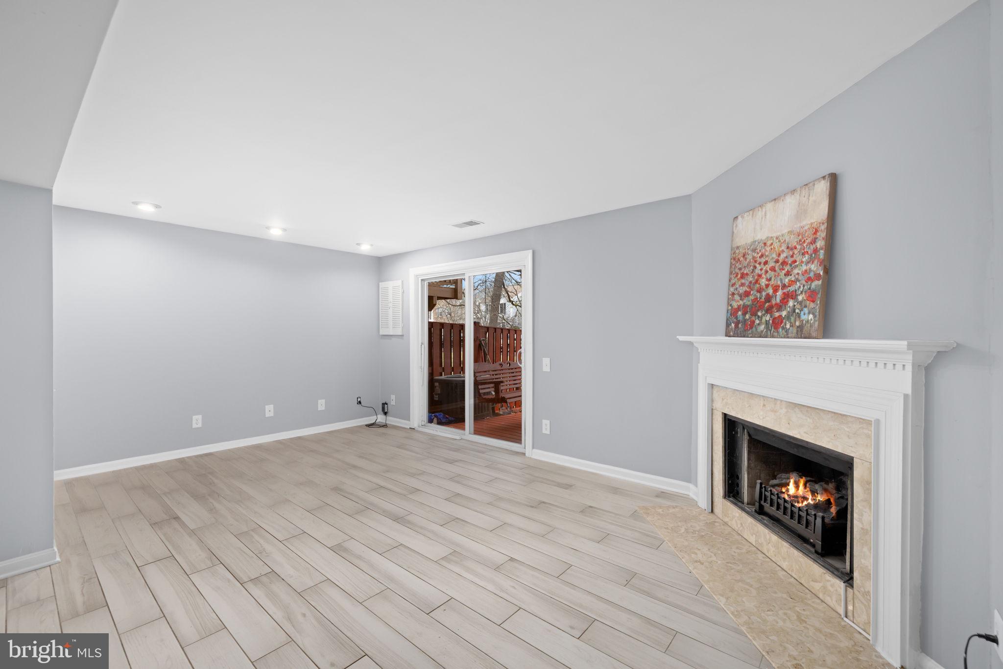 43861 Laburnum Square Ashburn, VA 20147 - Photo 38 of 46 a view of an empty room with wooden floor a fireplace and a window