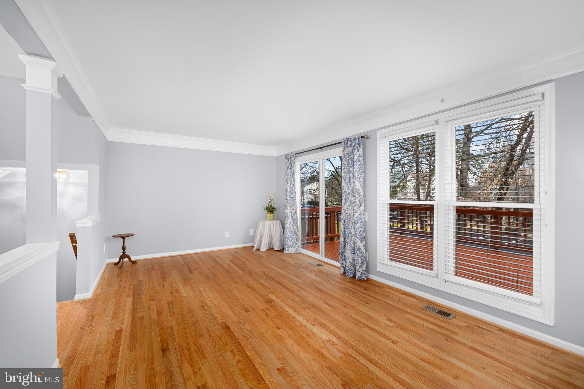 43861 Laburnum Square Ashburn, VA 20147 - Photo 9 of 46 a bedroom with a large bed and wooden floor
