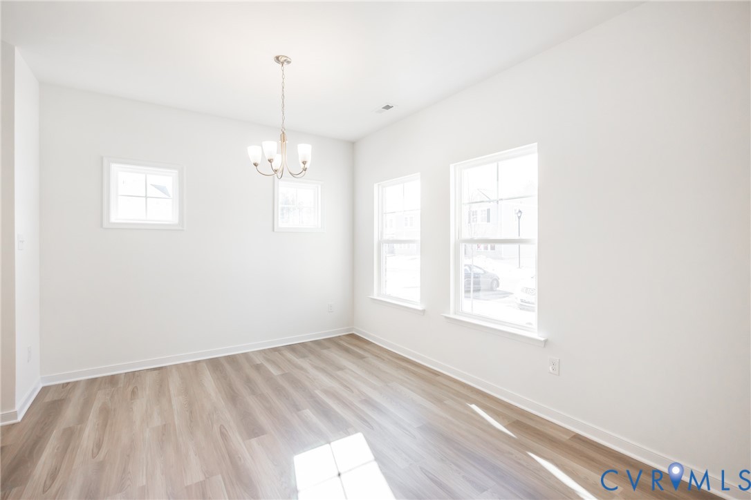 239 Greenpark Road Sandston, VA 23150 - Photo 2 of 31 wooden floor in an empty room with a window