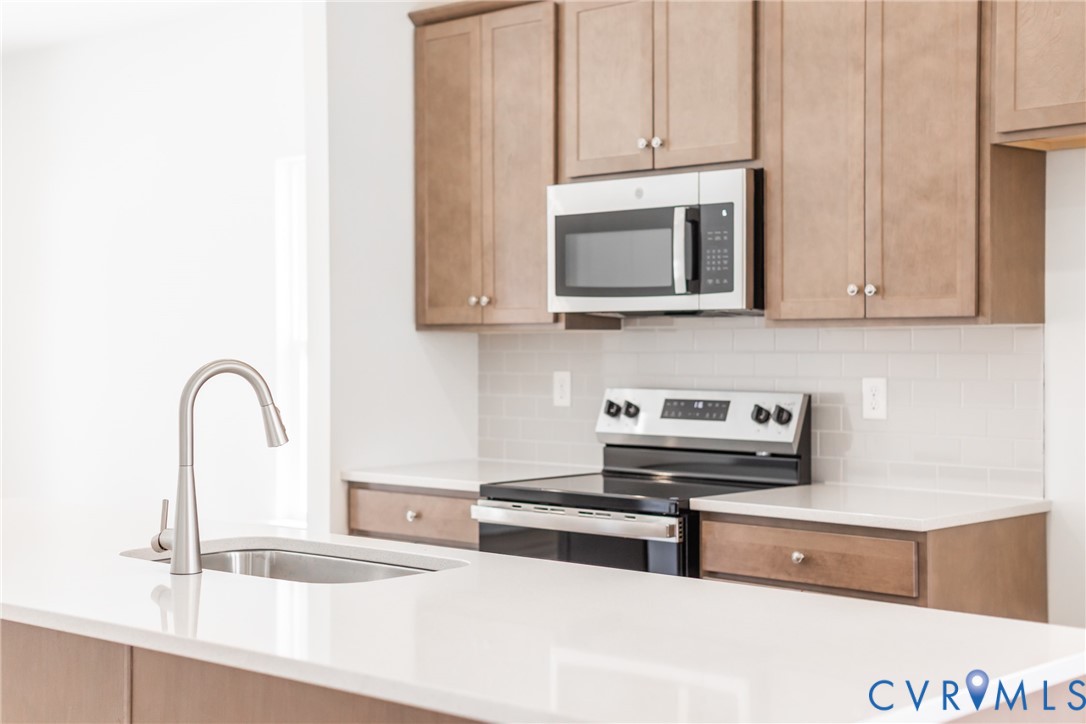 239 Greenpark Road Sandston, VA 23150 - Photo 6 of 31 a kitchen with stainless steel appliances granite countertop a stove a microwave and a sink