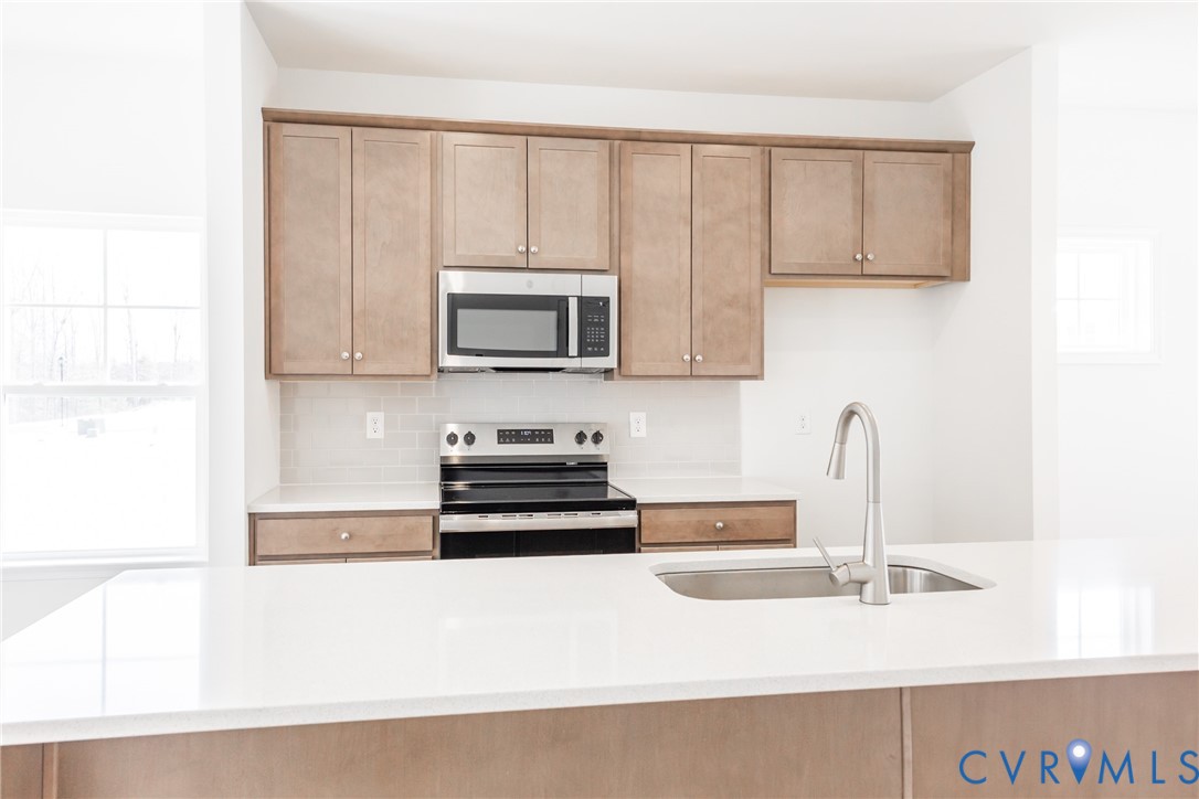 239 Greenpark Road Sandston, VA 23150 - Photo 7 of 31 a kitchen with a sink a microwave and cabinets
