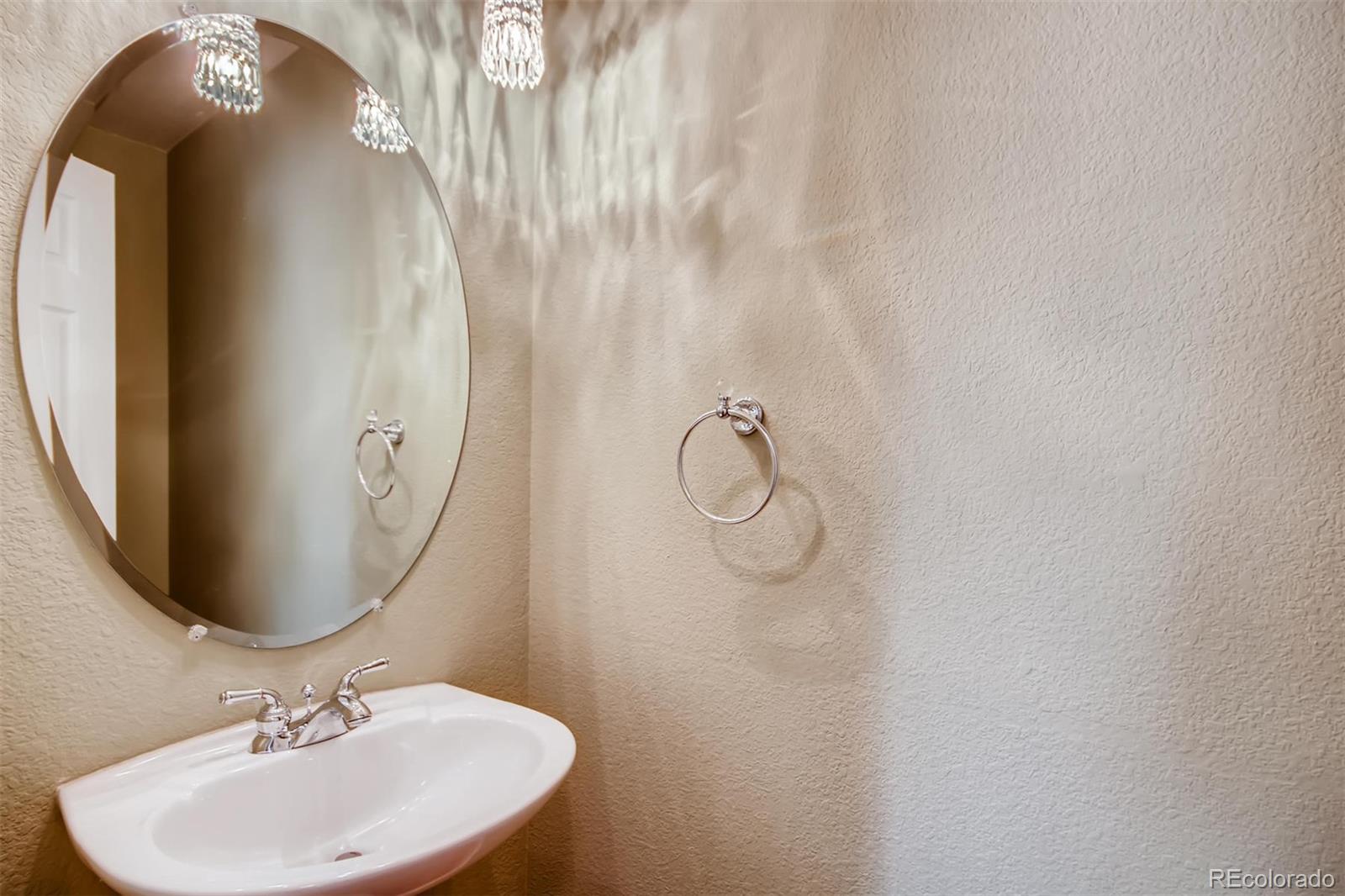 1518 Spring Water Way Highlands Ranch, CO 80129 - Photo 13 of 26 a bathroom with a sink and mirror