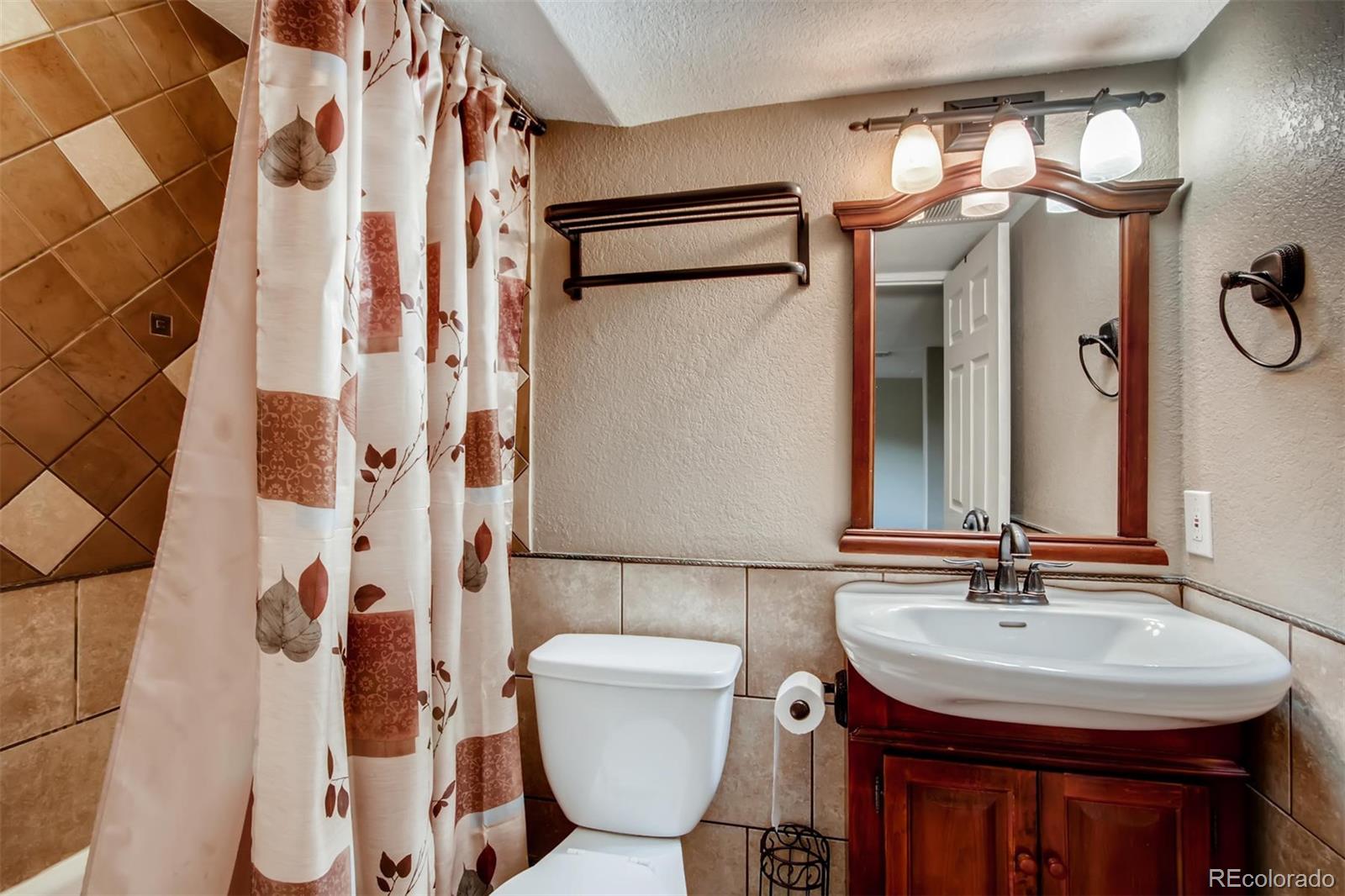 1518 Spring Water Way Highlands Ranch, CO 80129 - Photo 22 of 26 a bathroom with a sink and a mirror