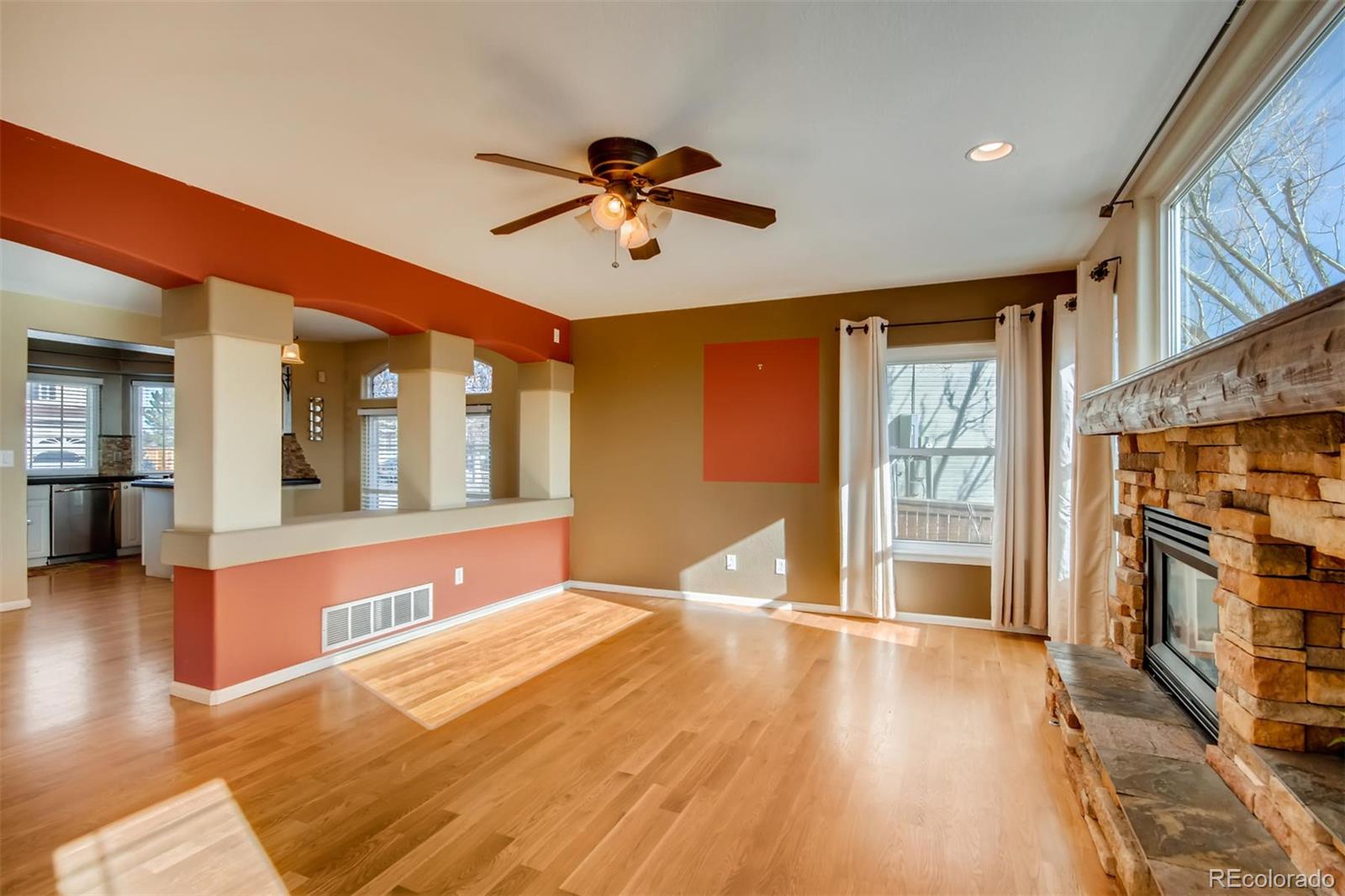 1518 Spring Water Way Highlands Ranch, CO 80129 - Photo 4 of 26 a view of an empty room with window and wooden floor