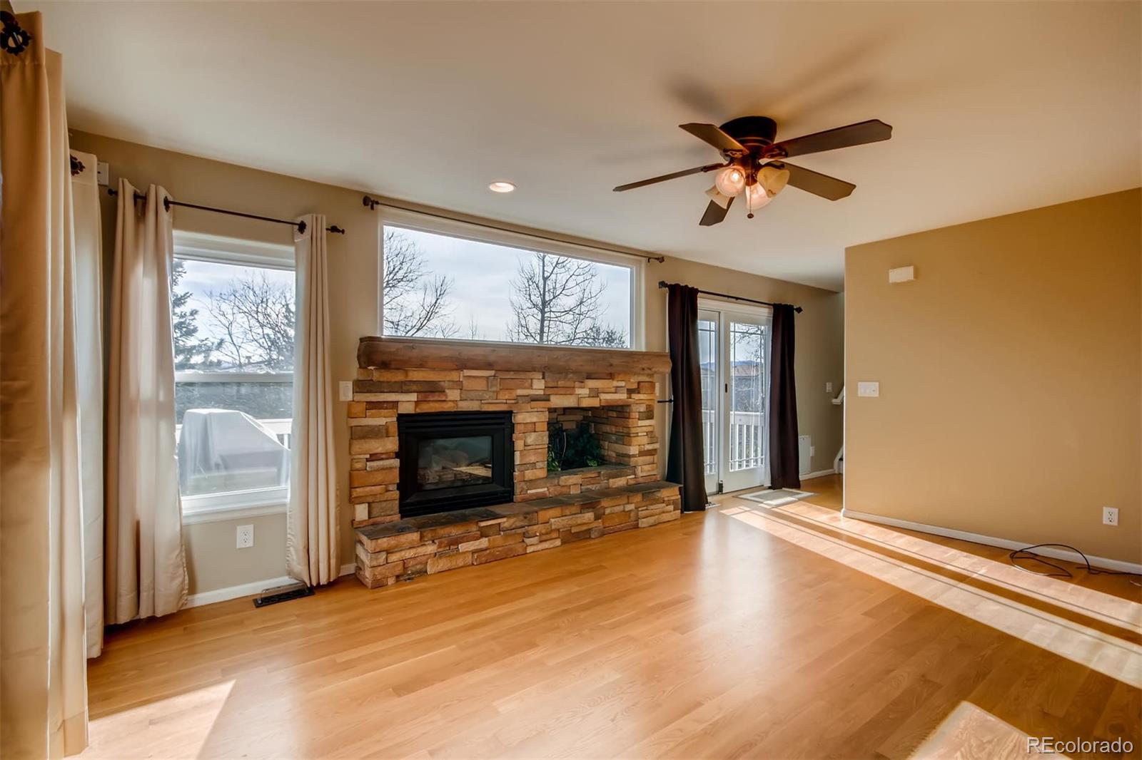 1518 Spring Water Way Highlands Ranch, CO 80129 - Photo 6 of 26 a view of a livingroom with a fireplace and window
