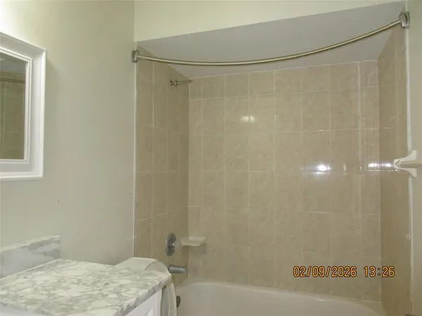 a bathroom with a shower and a bath tub