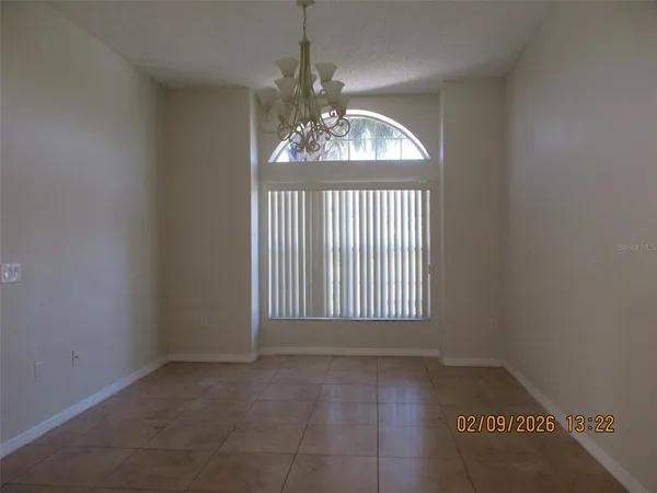an empty room that has a window in it