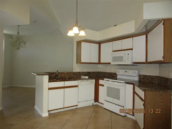 a kitchen with a stove cabinets and a counter top space
