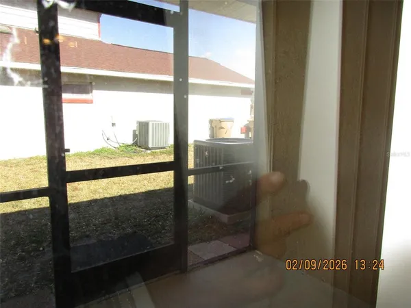 a view of a glass door with a yard from the window