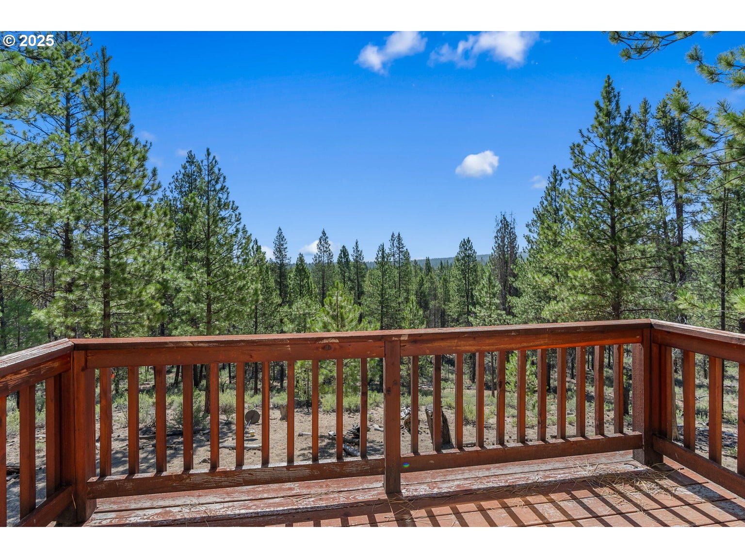 143970 Highway 97 Gilchrist, OR 97737 - Photo 13 of 30 a view of a roof deck with wooden floor and fence