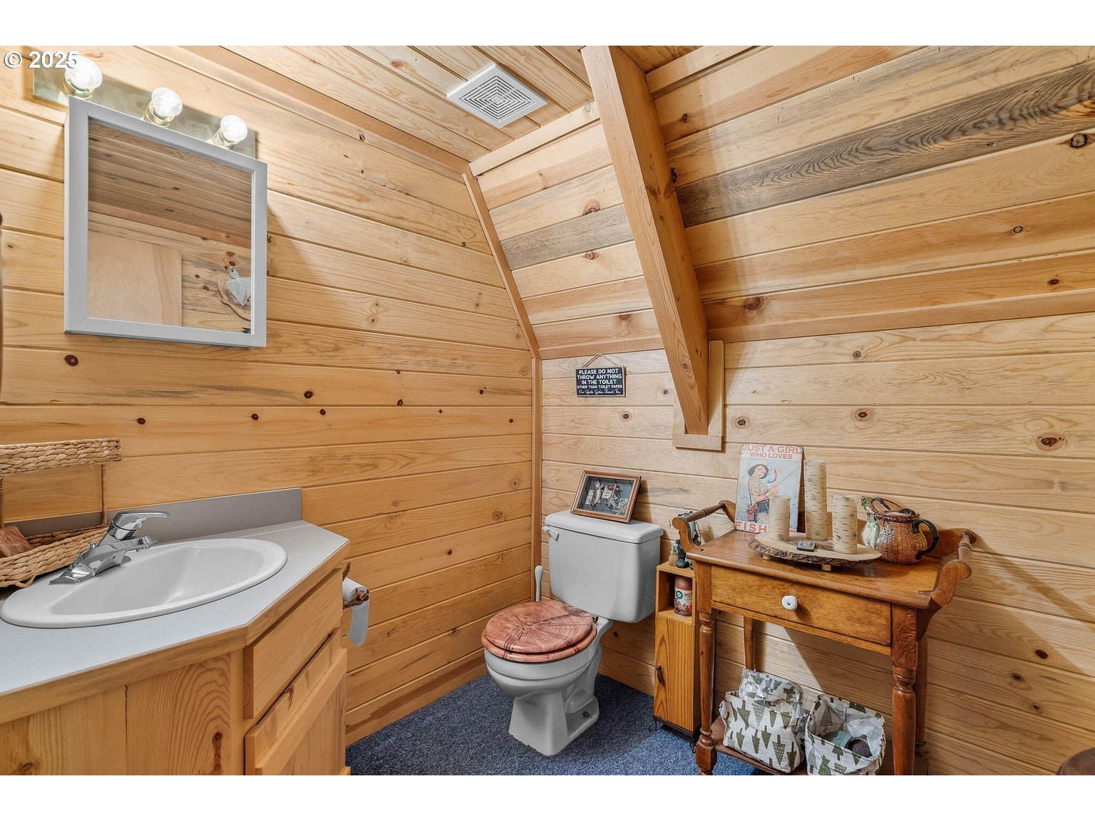 143970 Highway 97 Gilchrist, OR 97737 - Photo 14 of 30 a bathroom with a toilet sink and mirror