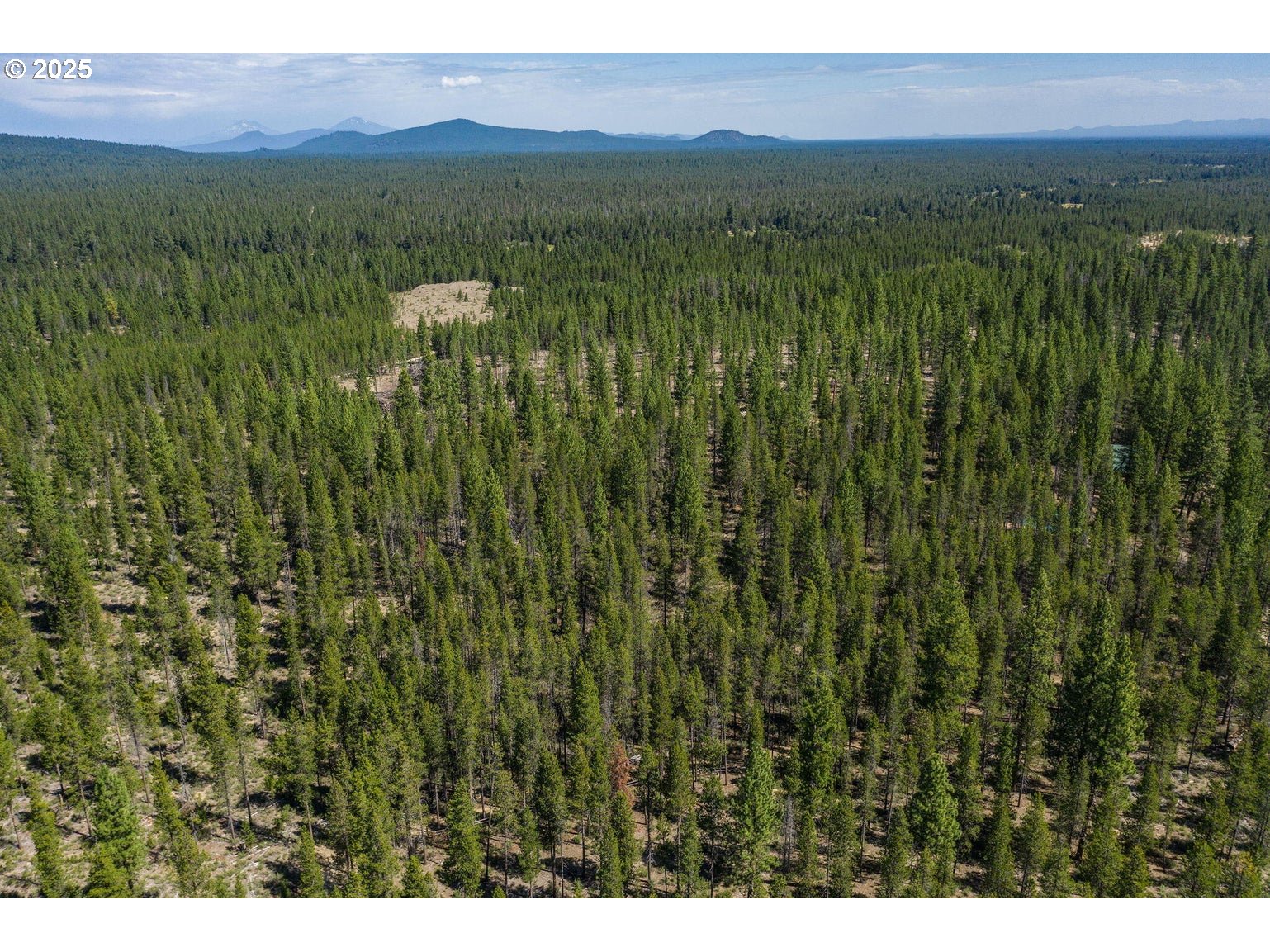 143970 Highway 97 Gilchrist, OR 97737 - Photo 26 of 30 a view of a lush green hillside and houses