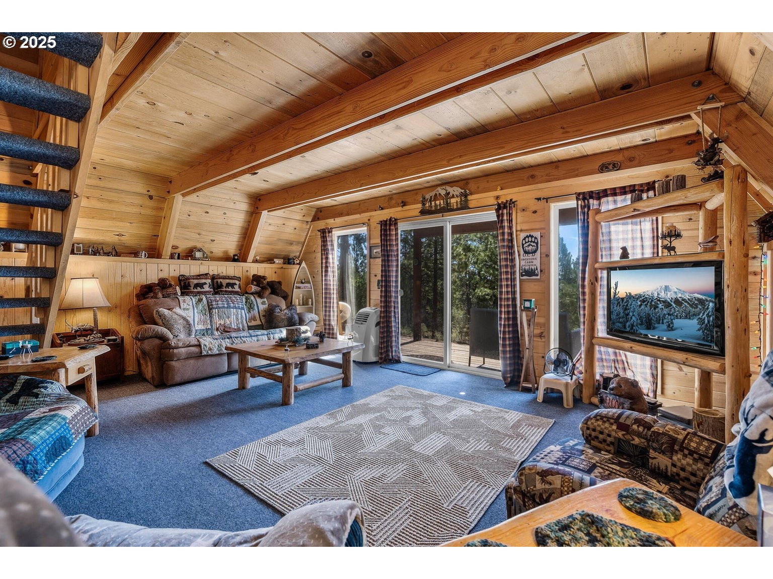 143970 Highway 97 Gilchrist, OR 97737 - Photo 6 of 30 a living room with furniture a rug and a large window