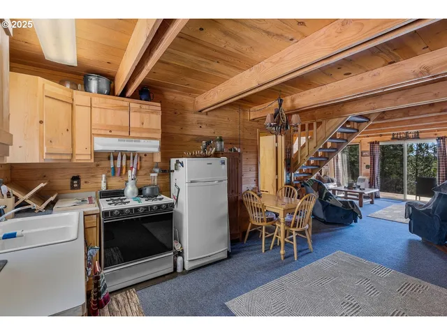 a living room with furniture a flat screen tv and a floor to ceiling window