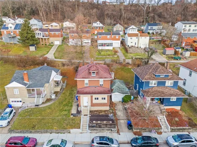an aerial view of residential houses and lake