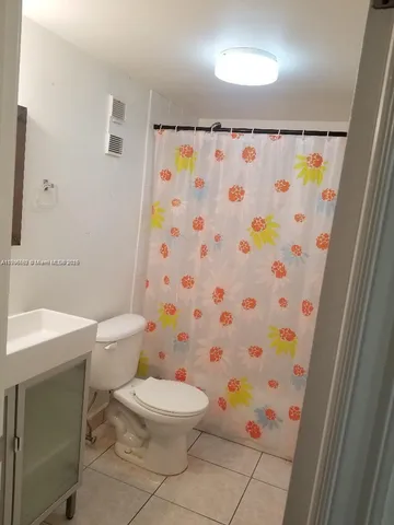 a white toilet sitting next to a bathroom sink and a sink