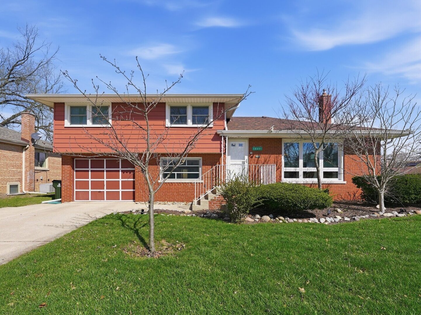 18441 Marshfield Avenue Homewood, IL 60430 - Photo 1 of 49 a front view of a house with a yard and garage