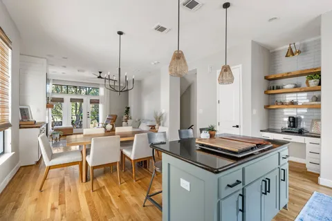 a dining table chairs and a wooden floor