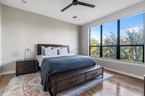 a spacious bedroom with a bed and a large window