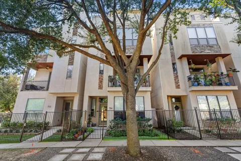 a front view of a residential apartment building with a yard