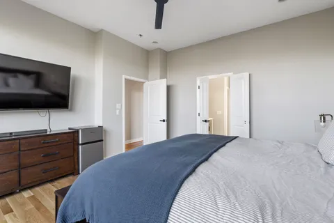 a bedroom with a bed and a flat screen tv