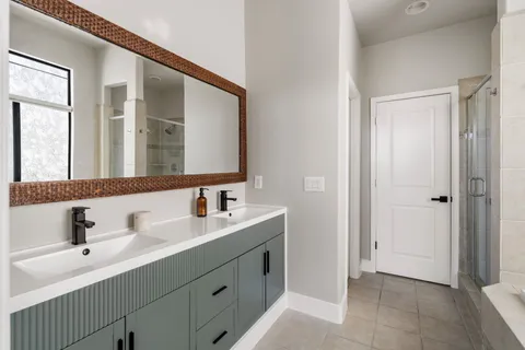 a bathroom with a double vanity sink mirror and