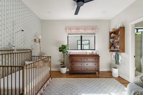 a living room with furniture and a baby crib