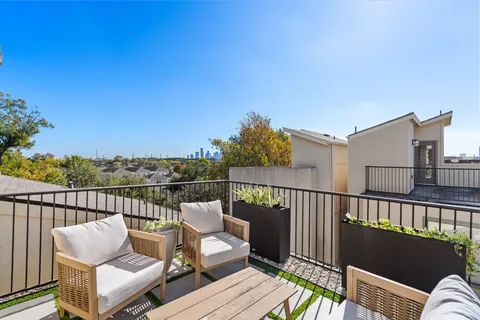 a view of a roof deck with wooden floor and outdoor seating