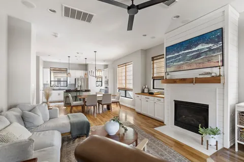 a living room with fireplace furniture and a fireplace